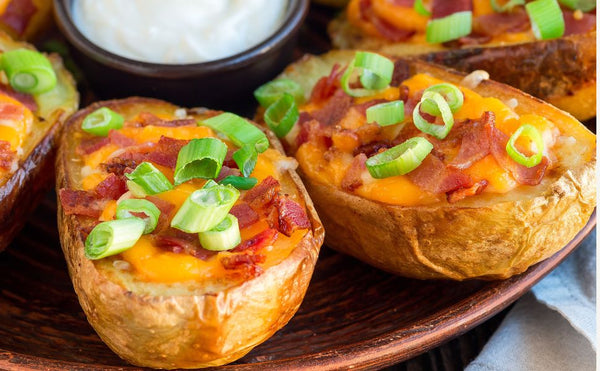 loaded baked potato skins on a ceramic kamado grill easy recipe family gathering bbq grill recipe cheese bacon appetizer 